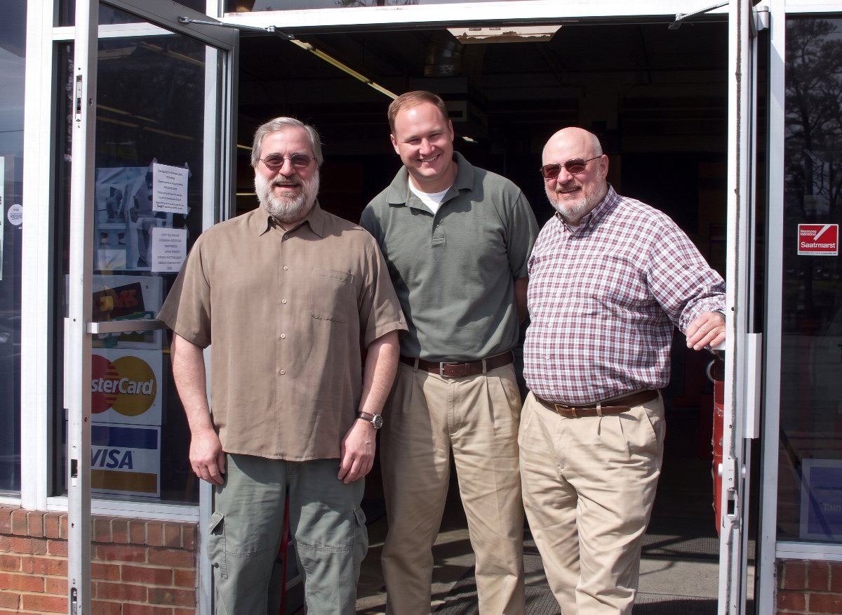 Three members of the Finn family standing in the entrance of Hull Street Outlet.