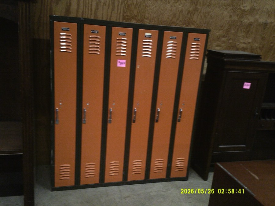 A six-door orange and black used metal locker unit.
