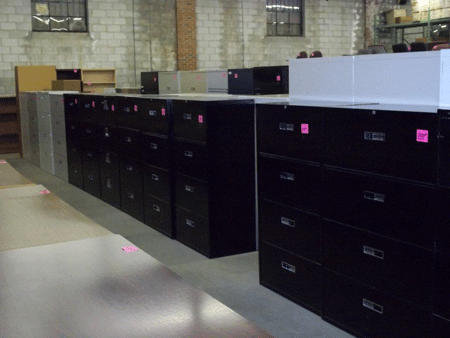 Rows of used black two- and three-drawer lateral file cabinets.
