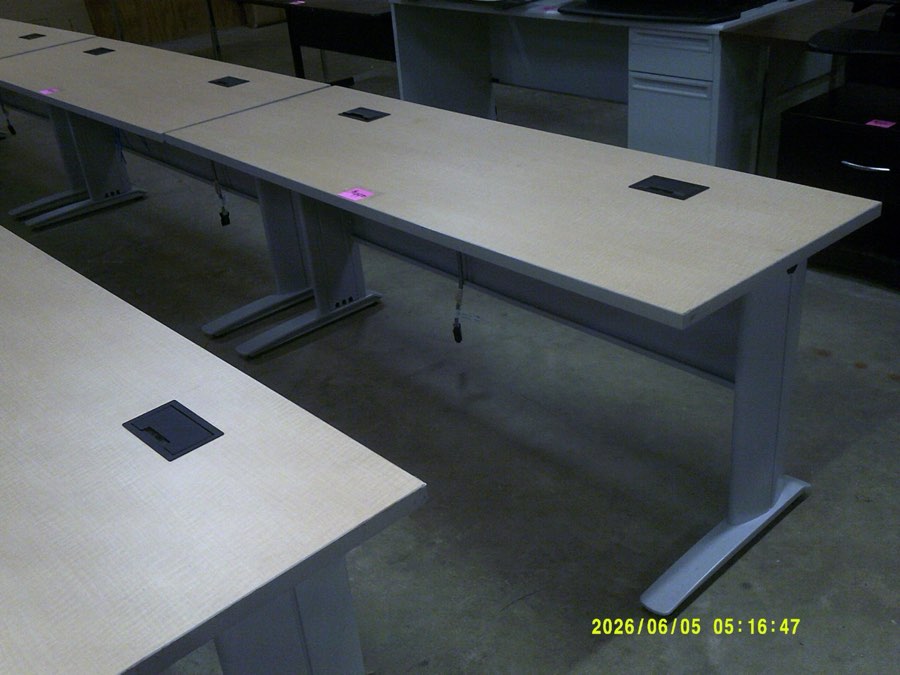 A grey laminate table desk with a steel base.