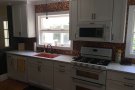 sink, stove, and cabinets